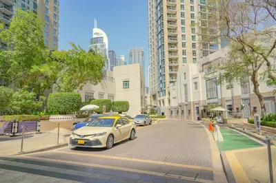 a white car parked on a street in a city at The Fountain Views Suite in Downtown Dubai in Dubai