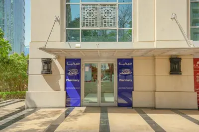 a building with a revolving door in front of it at The Fountain Views Suite in Downtown Dubai in Dubai