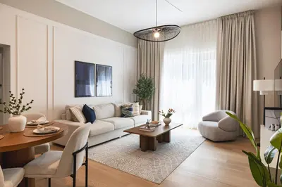a living room with a couch and a table at The Fountain Views Suite in Downtown Dubai in Dubai