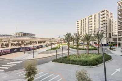 an empty street with palm trees and a building at Lagoon and Beach Access, Near Festival City Mall, Mins From Downtown Dubai, Rosewater at Creek Beach Building 2, Creek Beach by Deluxe Holiday Homes in Dubai