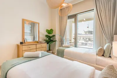 a bedroom with two beds and a window at Lagoon and Beach Access, Near Festival City Mall, Mins From Downtown Dubai, Rosewater at Creek Beach Building 2, Creek Beach by Deluxe Holiday Homes in Dubai