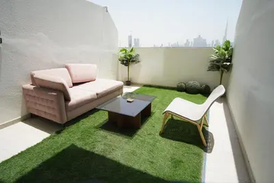 a living room with a couch and a table at Spacious Studio with full Burj Khalifa view Jaddaf in Dubai
