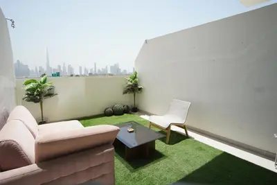 a living room with a couch and a table at Spacious Studio with full Burj Khalifa view Jaddaf in Dubai