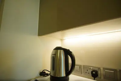 a coffee pot sitting on top of a kitchen counter at Spacious Studio with full Burj Khalifa view Jaddaf in Dubai