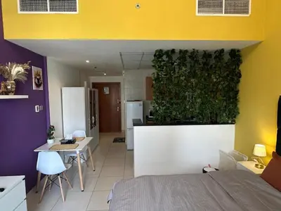 a room with a large plant on the wall at Livincci - Luxury Studio in Dubai Marina - 16 in Dubai