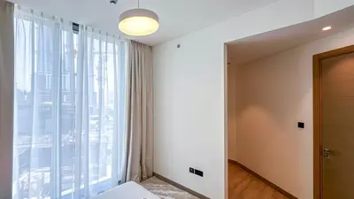 a bedroom with a large window and a bed at Spacious 2BR, Sobha Waves, Family-Friendly Stay - 3AB11 in Dubai