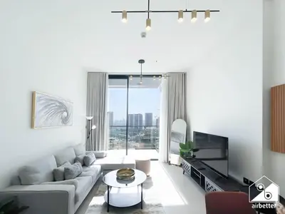 a living room with a couch and a tv at Bright and Modern 1BR Binghatti Amber with City View in Dubai