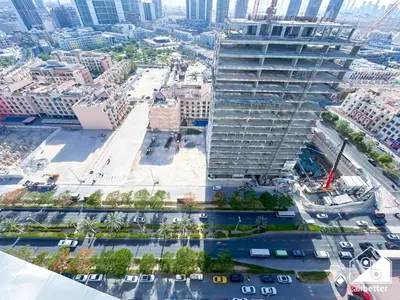 an aerial view of a tall building in a city at Bright and Modern 1BR Binghatti Amber with City View in Dubai