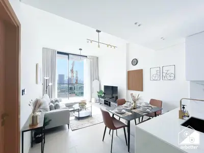 a kitchen and living room with a table and chairs at Cozy Luxury l1BR Apartment in Binghatti Amber in Dubai