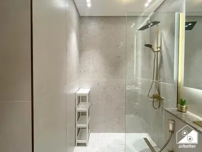 a bathroom with a shower with a glass door at Cozy Luxury l1BR Apartment in Binghatti Amber in Dubai