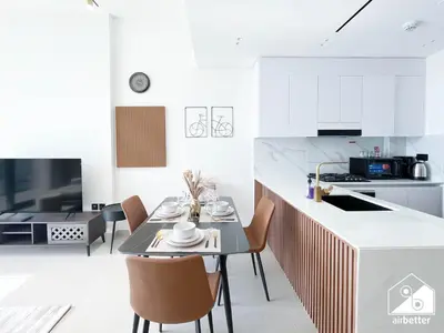 a kitchen and dining room with a table and chairs at Cozy Luxury l1BR Apartment in Binghatti Amber in Dubai