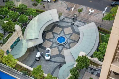 an aerial view of a circular courtyard with a car at White House With Burj Views, Free Parking in Dubai