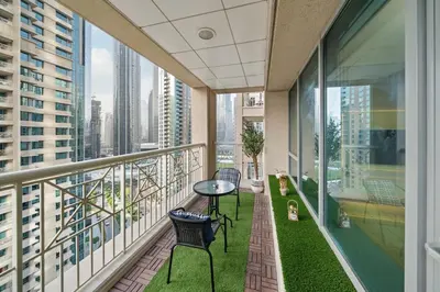 a balcony with a table and chairs on a building at White House With Burj Views, Free Parking in Dubai