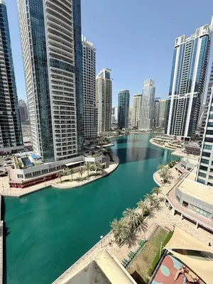 a river in the middle of a city with tall buildings at Livincci - Luxury 1 Bed Apartment in JLT-10 in Dubai