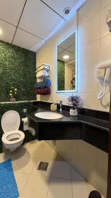 a bathroom with a toilet and a sink and a mirror at Livincci - Luxury 1 Bed Apartment in JLT-10 in Dubai
