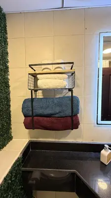 a group of towels on a shelf in a bathroom at Livincci - Luxury 1 Bed Apartment in JLT-10 in Dubai