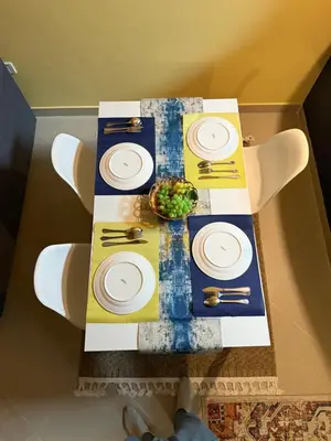 a table with plates and a bowl of food on it at Livincci - Luxury 1 Bed Apartment in JLT-10 in Dubai