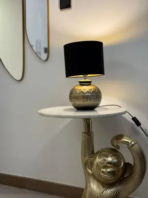 a table with a lamp on top of it at Canal View 1BR - Business Bay - Fully Furnished in Dubai