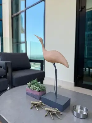 a statue of a bird on a table in a living room at Canal View 1BR - Business Bay - Fully Furnished in Dubai