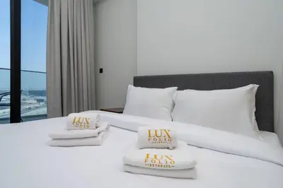 a white bed with two pillows on top of it at Contemporary Studio Getaway in Jebel Ali in Dubai