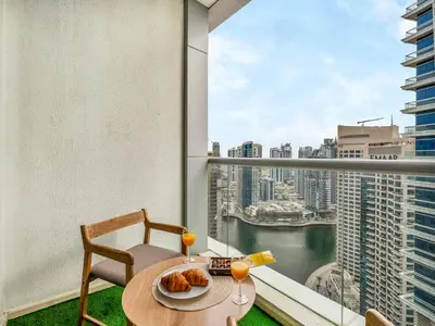 a table with food and drinks on a balcony with a view at Best Marina & Ain Dubai View | Steps to JBR beach in Dubai