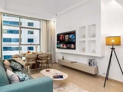 a living room with a couch and a table at Best Marina & Ain Dubai View | Steps to JBR beach in Dubai