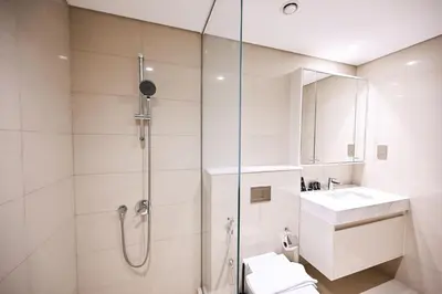 a bathroom with a shower and a toilet and a sink at New Luxe 2BR in Burj Royale, 1 Min Walk to Dubai Mall,40th Floor, Burj Khalifa View Pool, Wifi, Gym in Dubai