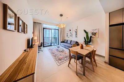 a living room with a table and a couch at Creek Crescent by Emaar, Dubai Creek Harbour in Dubai