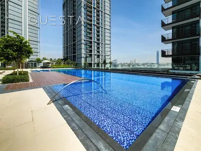 a swimming pool in the middle of a building with tall buildings at Creek Crescent by Emaar, Dubai Creek Harbour in Dubai