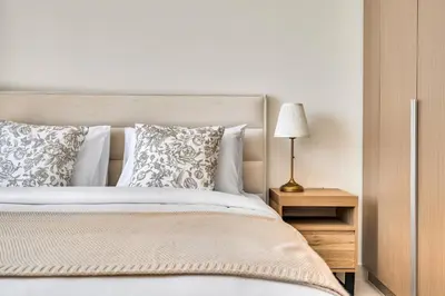 a bedroom with a bed and a lamp on a night stand at 1-Bed at Creek Beach with Pool, Gym and Balcony in Dubai