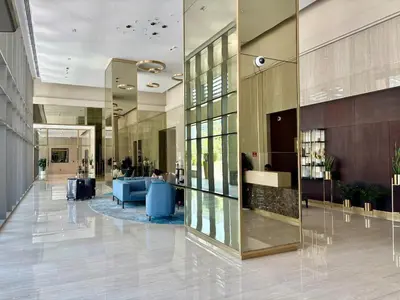 a lobby of a building with glass walls and a lobby at The Greendoor Downtown - Burj view in Dubai