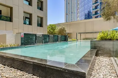 a swimming pool in the middle of a building at Knokey Cozy Studio Apartments in Business Bay in Dubai