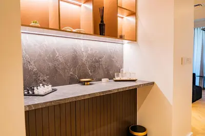 a bathroom with a counter with a marble counter top at Creek Harbour Skyline Burj Khalifa & Sea View in Dubai