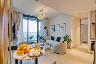 a living room with a couch and a table with fruit on it at Address Beach Resort - 1BDR With Private Beach in Dubai
