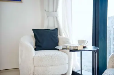 a living room with a chair and a table at Address Beach Resort - 1BDR With Private Beach in Dubai