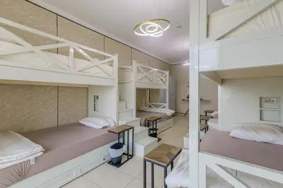 a room with two bunk beds and two tables at Apartment in Downtown As Dormitory Room for male in Dubai