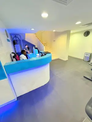 two people sitting at a counter in a room at Oceana Residences Holiday Beach Home in Dubai