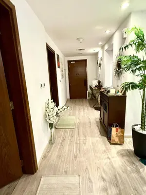 an office with a hallway with a desk and plants at Oceana Residences Holiday Beach Home in Dubai