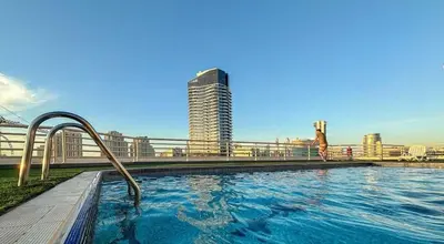 a swimming pool on the side of a building at Manchester Tower Dubai Marina in Dubai