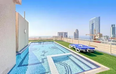 a swimming pool on the roof of a building at Manchester Tower Dubai Marina in Dubai