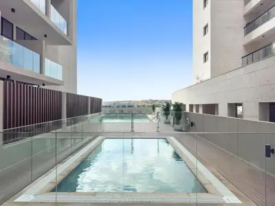 a swimming pool in the middle of a building at Modern Studio close to Marina with Balcony - 5 min walk from Metro in Dubai