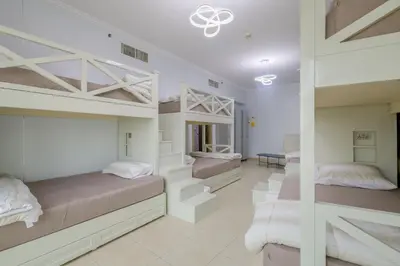 a bedroom with two bunk beds and a hallway at Apartment in Downtown As Dormitory Room for female in Dubai
