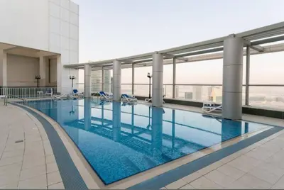 a large swimming pool on top of a building at Apartment in Downtown As Dormitory Room for female in Dubai