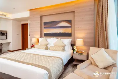 a hotel room with a bed and a chair at Emmar fashion avenue Dubai mall in Dubai