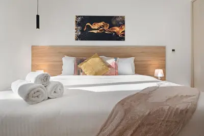 a bedroom with a white bed with towels on it at Luxury 1BR Suite I Boulevard View I Downtown Dubai in Dubai