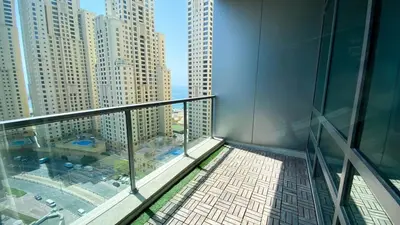 a balcony of a building with a view of a city at Sky High luxury Stay in Dubai Marina ,with Marina View, High Floor, Modern Design, Pool Access by Stay Vista! Up to 6 Guests in Dubai