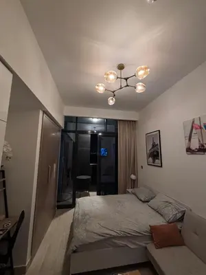 a bedroom with a bed and a chandelier at Azizi Riviera 1 A in Dubai