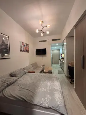 a bedroom with a bed and a living room at Azizi Riviera 1 A in Dubai
