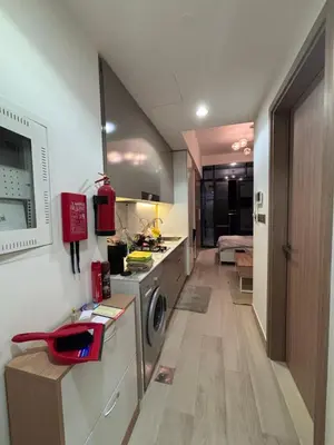 a kitchen with a stove and a washing machine at Azizi Riviera 1 A in Dubai