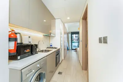 a kitchen with a sink and a dishwasher at PVH - Cozy Studio in Azizi Riviera 43 in Dubai